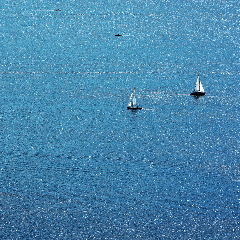 Ausblick auf das Wasser mit zwei kleinen Segelbooten